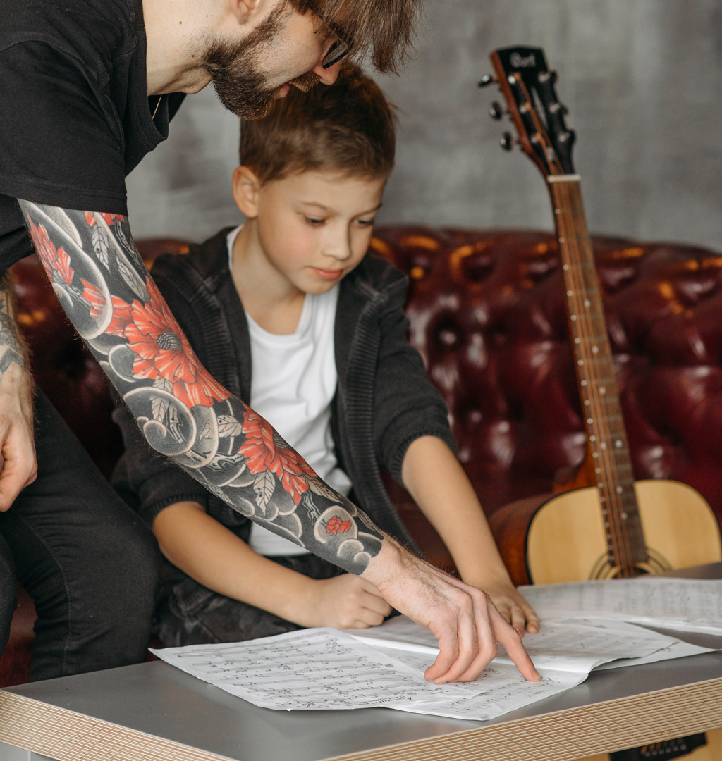 Musicology instructor working with a young music student